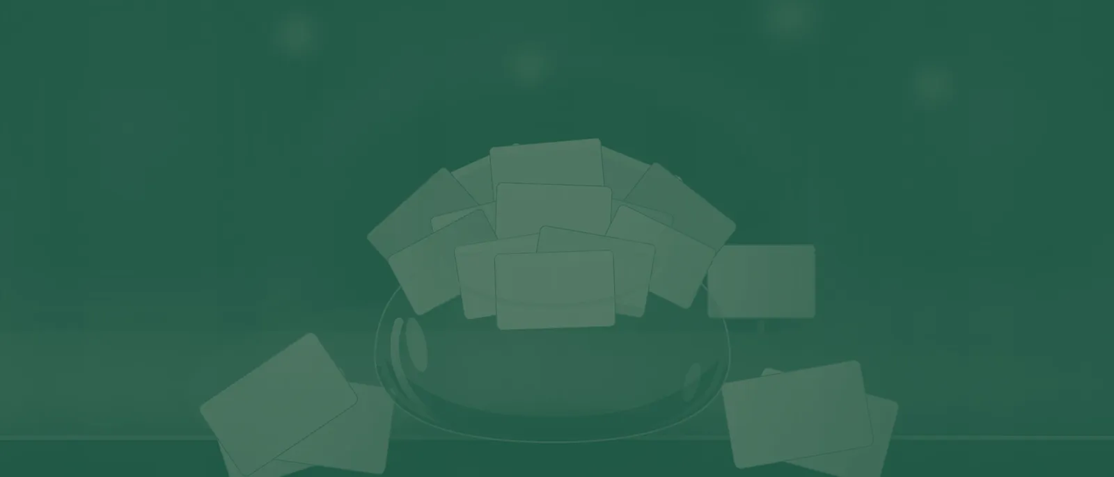 A glass fishbowl heaped with collected business cards on a booth counter, a few cards spilled beside it